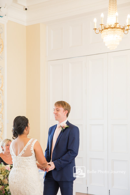 Bride and groom uniting in front of registrar