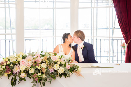 wedded couple signing at registrar